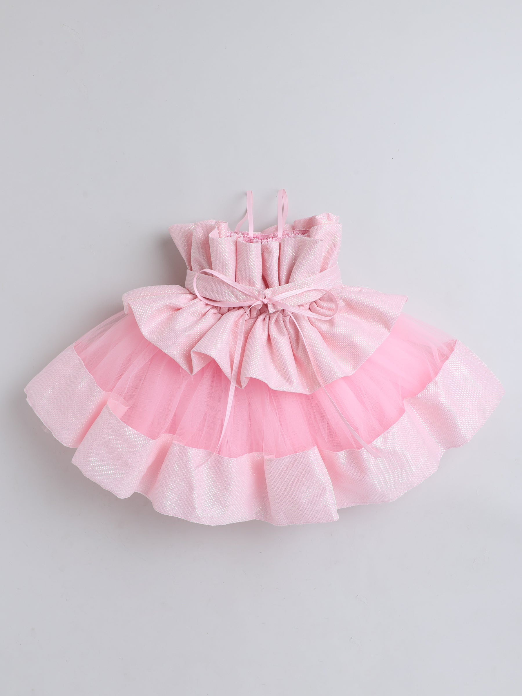 "Dreamy tutu gown featuring a shimmery bow belt, layered ruffles, and delicate straps – perfect for birthdays,