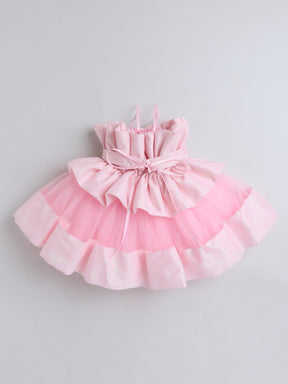 "Dreamy tutu gown featuring a shimmery bow belt, layered ruffles, and delicate straps – perfect for birthdays,