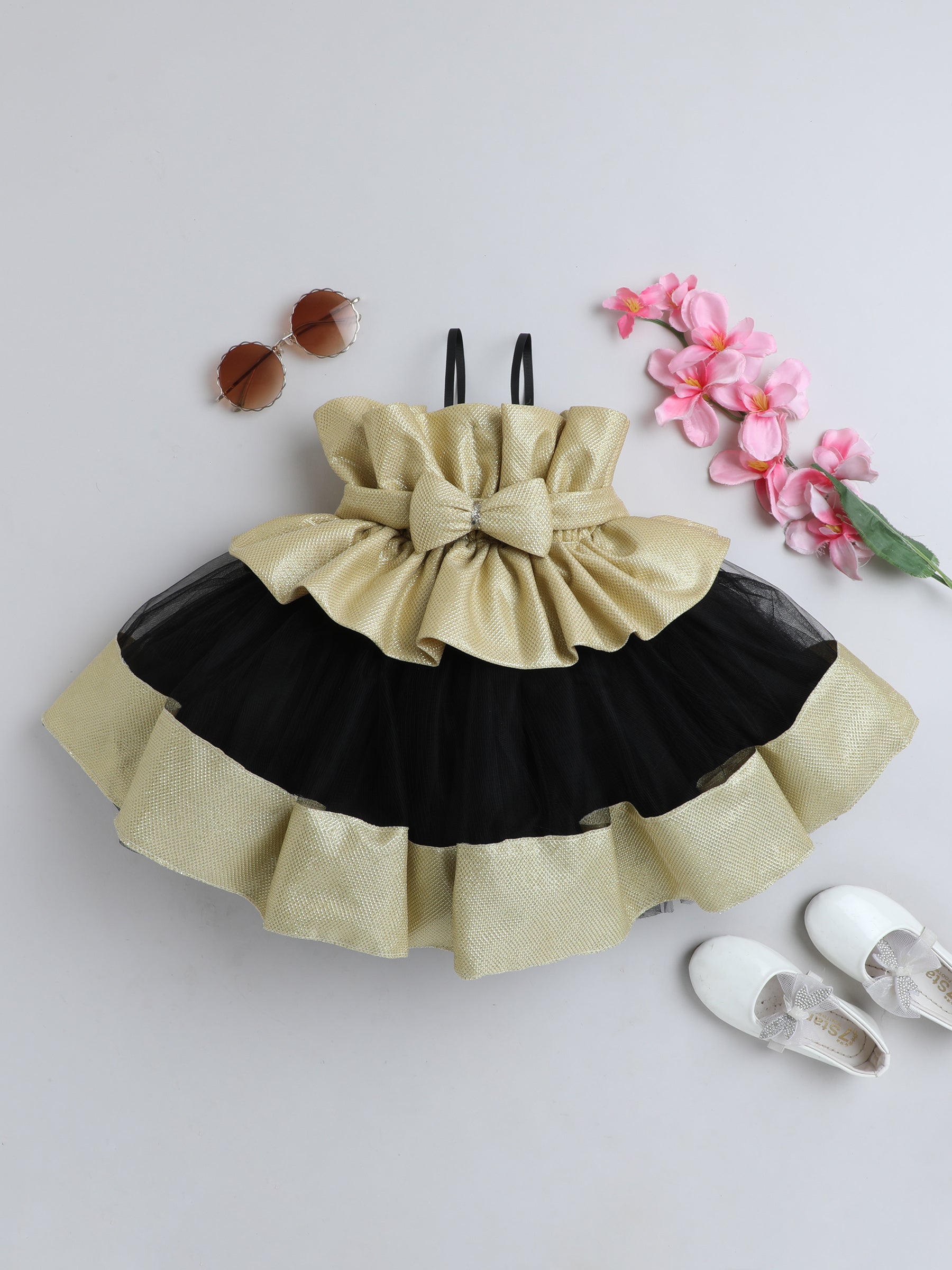 "Dreamy tutu gown featuring a shimmery bow belt, layered ruffles, and delicate straps – perfect for birthdays,