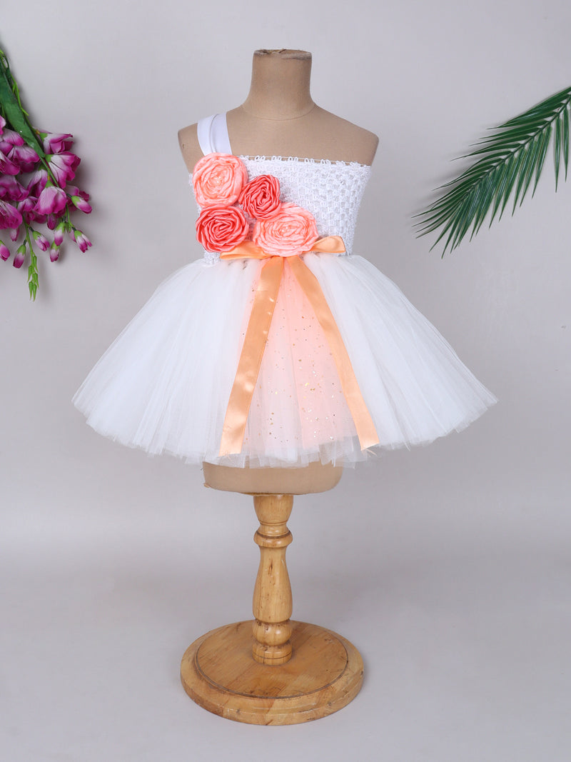 "One-shoulder peach bloom tutu gown with floral accents – perfect for special occasions."