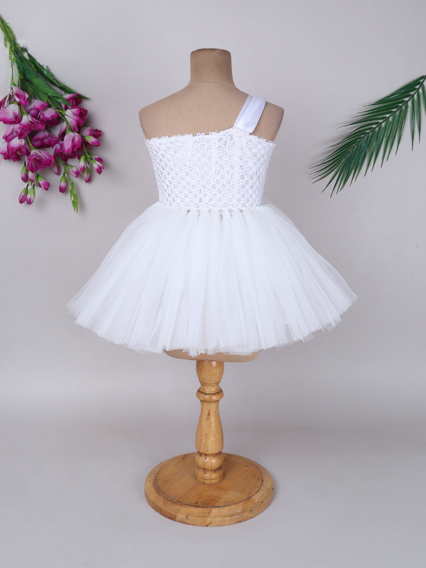 "One-shoulder peach bloom tutu gown with floral accents – perfect for special occasions."