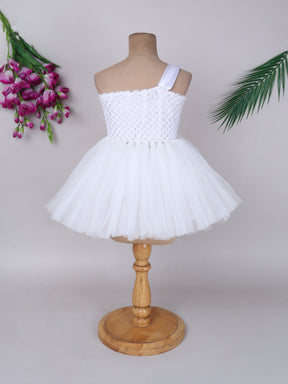 "One-shoulder peach bloom tutu gown with floral accents – perfect for special occasions."