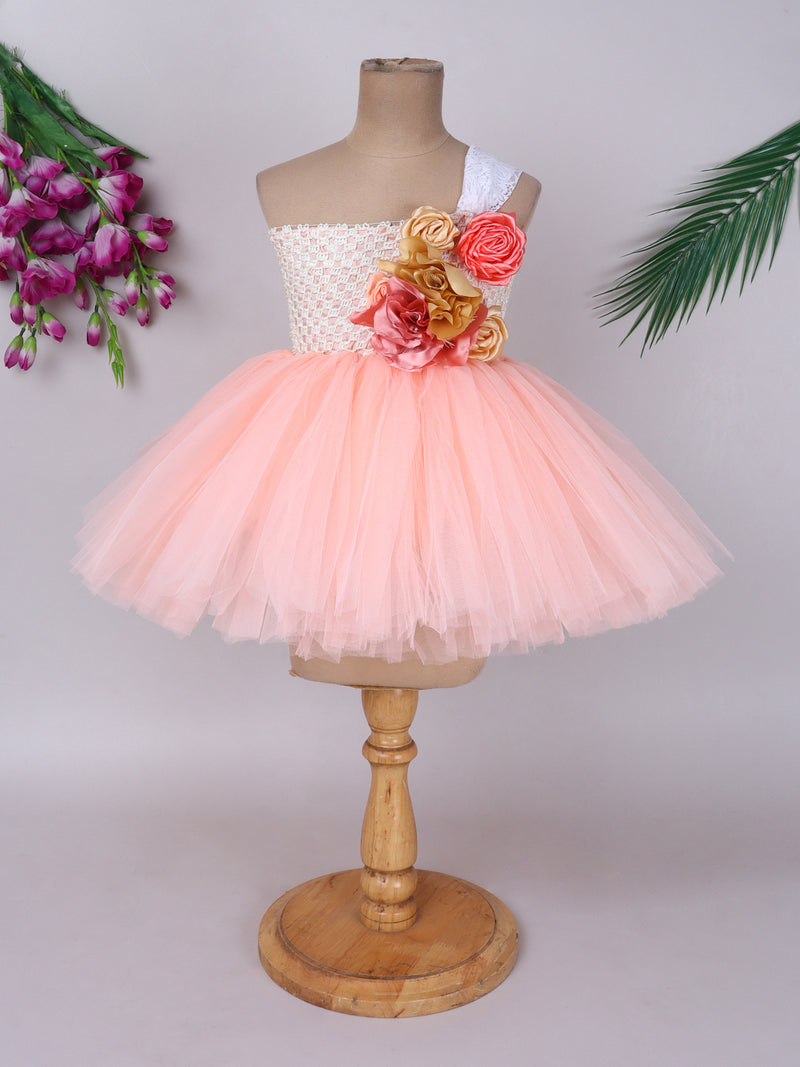"Blush peach floral tutu gown – one-shoulder elegance for your little star."